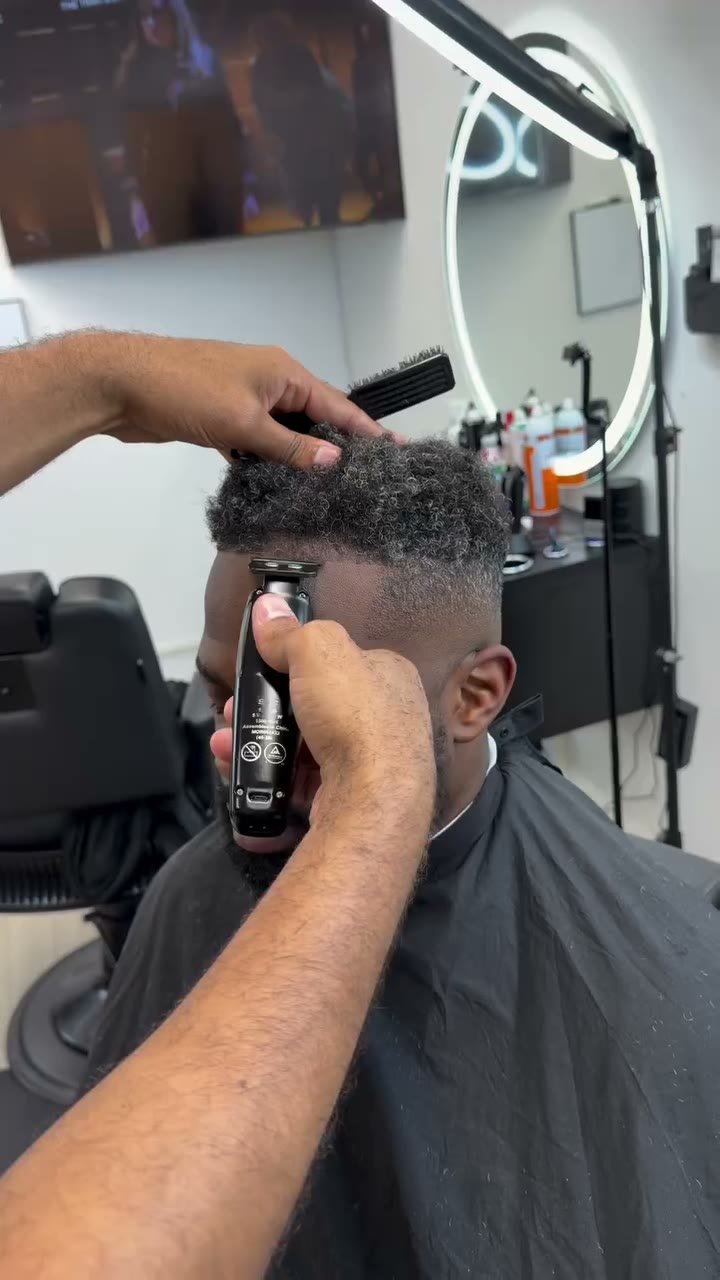 Barber giving a client a precision fade at Phoenix Barber Studio